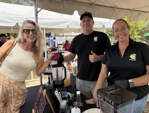smoothie vendor serving freshly blended drinks at the San Nicolas Pop-Up Market in Aruba.
