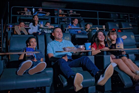 Moviegoers enjoying VIP seating at Caribbean Cinemas Paseo Herencia Aruba