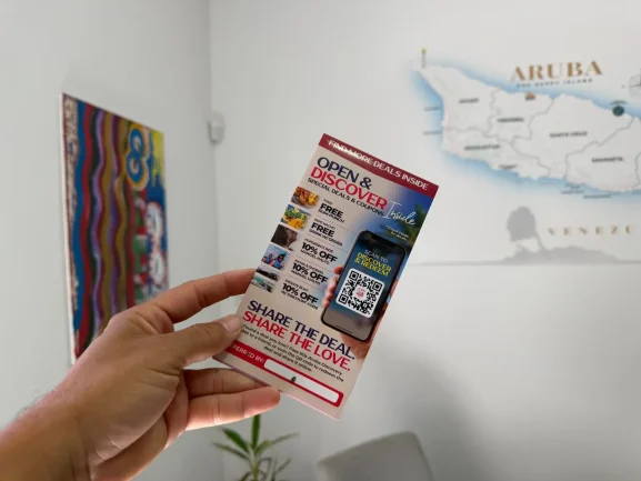 Traveler holding an Aruba Discovery Deals and Coupons guide
