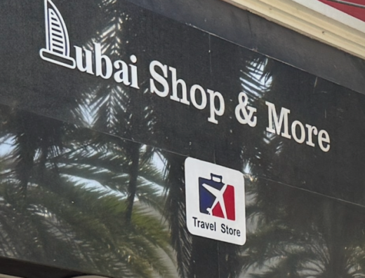 Exterior sign reading Dubai Shop & More with a Travel Store logo.
